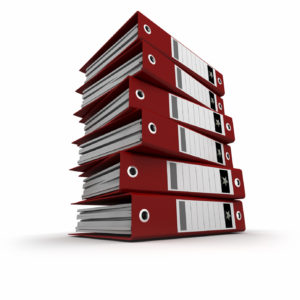 A pile of red ring binders against a white background